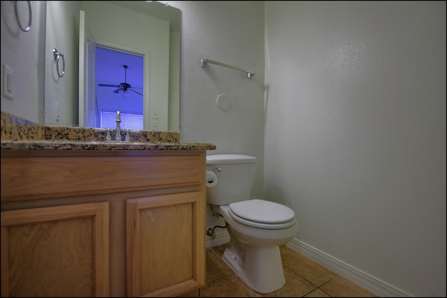 bathroom featuring tile patterned floors, baseboards, toilet, vanity, and a ceiling fan