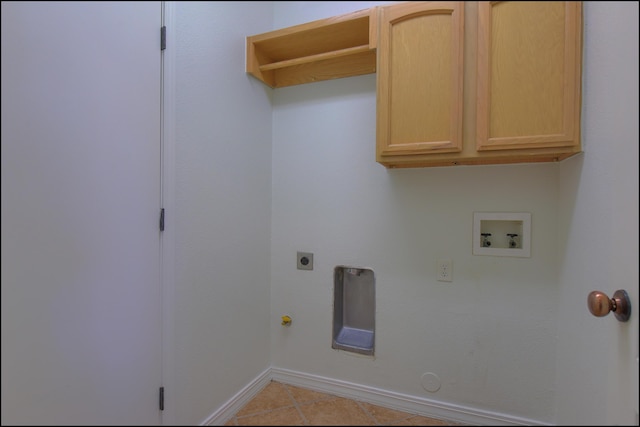clothes washing area with hookup for a gas dryer, electric dryer hookup, hookup for a washing machine, baseboards, and light tile patterned flooring