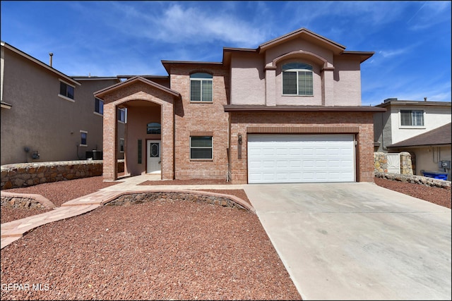 1493 Luz De Sol Dr, El Paso, TX 79912 - view of front of property with driveway, a garage, central air condition unit, and brick siding
