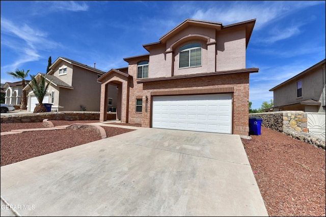 1493 Luz De Sol Dr, El Paso, TX 79912 - traditional-style home with concrete driveway, a garage, and brick siding
