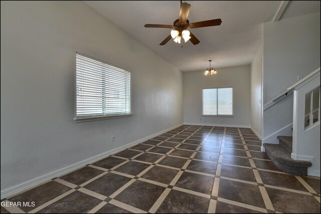 1493 Luz De Sol Dr, El Paso, TX 79912 - spare room with stairway, lofted ceiling, a ceiling fan, baseboards, and a chandelier