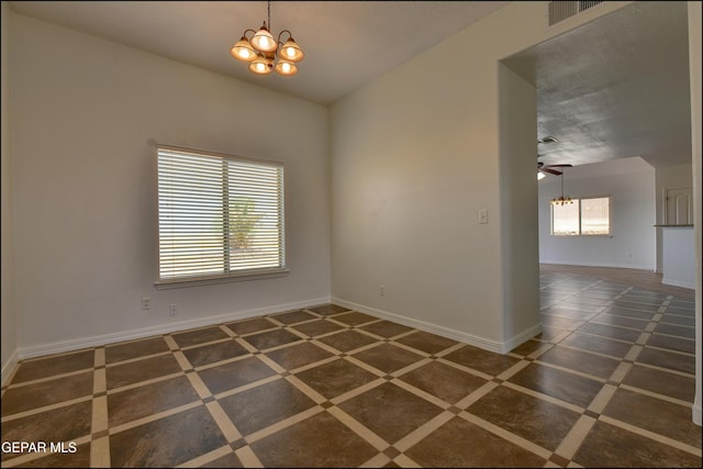 1493 Luz De Sol Dr, El Paso, TX 79912 - empty room with a chandelier, baseboards, and a ceiling fan