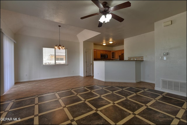 1493 Luz De Sol Dr, El Paso, TX 79912 - kitchen with brown cabinets, a chandelier, stainless steel microwave, fridge, and ceiling fan