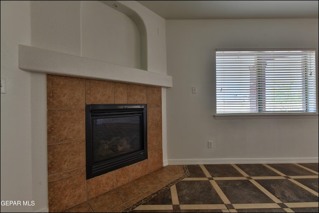 1493 Luz De Sol Dr, El Paso, TX 79912 - detailed view of inlaid floor details, a tile fireplace, and baseboards