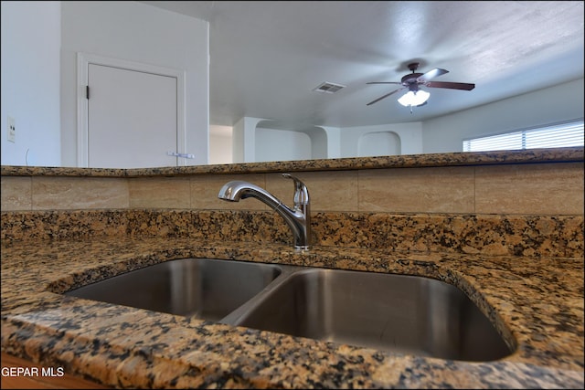 1493 Luz De Sol Dr, El Paso, TX 79912 - detailed view of a sink, backsplash, dark stone countertops, and ceiling fan