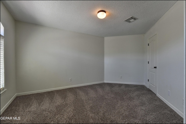 1493 Luz De Sol Dr, El Paso, TX 79912 - empty room featuring dark colored carpet, a textured ceiling, and baseboards
