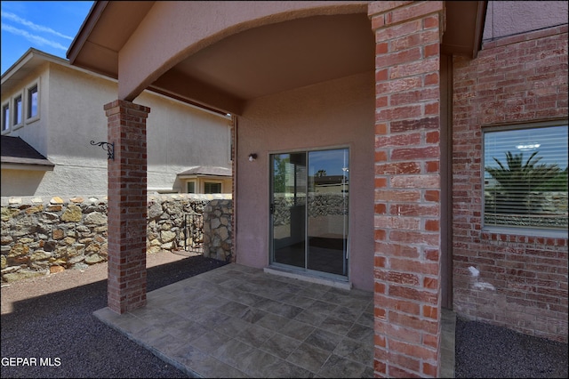 1493 Luz De Sol Dr, El Paso, TX 79912 - entrance to property featuring a patio area, brick siding, and stucco siding