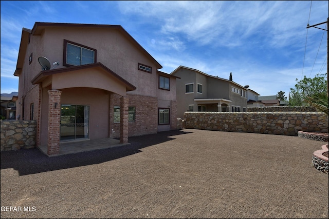 1493 Luz De Sol Dr, El Paso, TX 79912 - rear view of property featuring stucco siding, a patio area, and brick siding