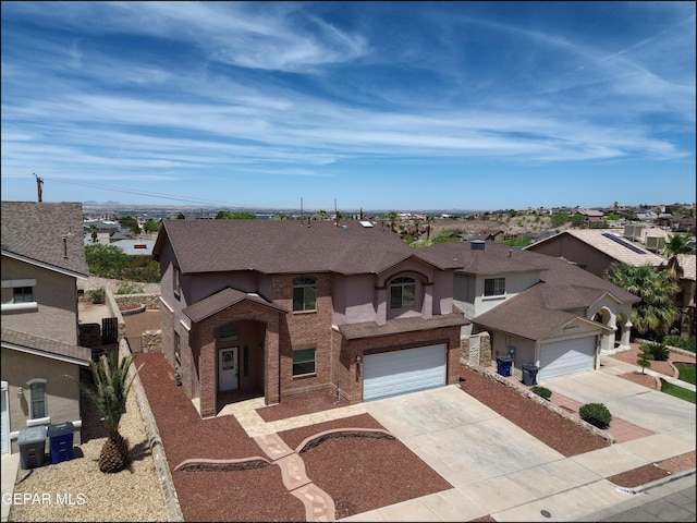 1493 Luz De Sol Dr, El Paso, TX 79912 - view of front of house featuring a residential view, concrete driveway, an attached garage, and roof with shingles
