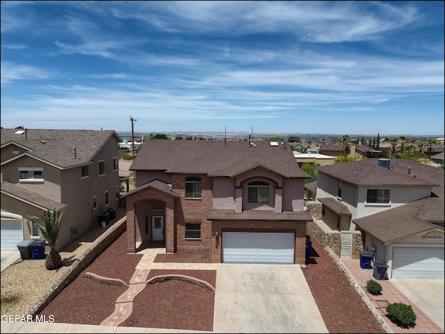 1493 Luz De Sol Dr, El Paso, TX 79912 - view of front facade with driveway, a residential view, an attached garage, roof with shingles, and brick siding