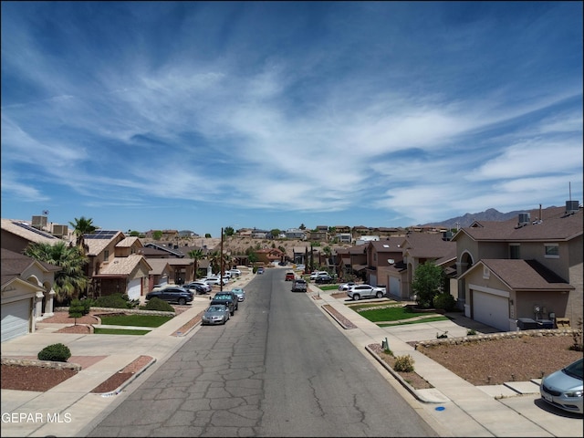 1493 Luz De Sol Dr, El Paso, TX 79912 - view of asphalt road with a residential view, sidewalks, and curbs