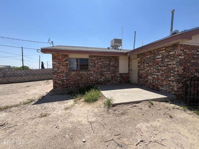 9125 Elgin Dr, El Paso, TX 79907 - back of property with a patio, brick siding, and central AC