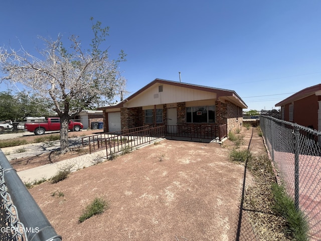 9125 Elgin Dr, El Paso, TX 79907 - view of front of house featuring brick siding, a garage, fence, and concrete driveway