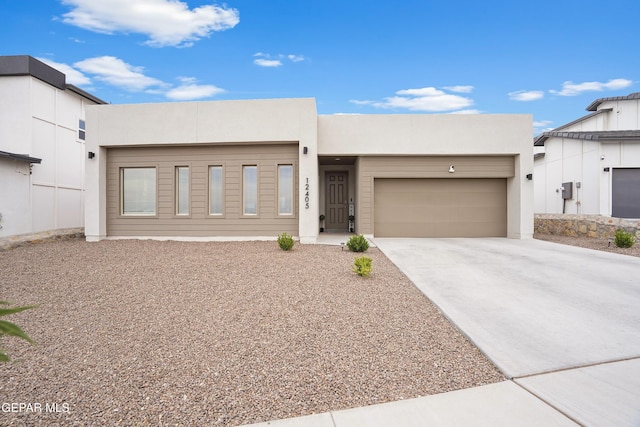 12405 Northumberg Dr, El Paso, TX 79928 - view of front of home with an attached garage, concrete driveway, and stucco siding