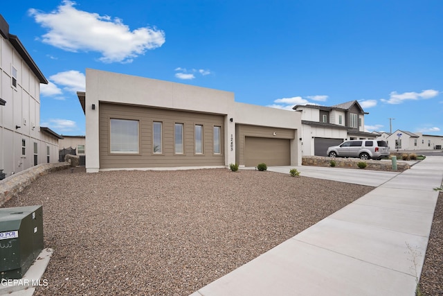 12405 Northumberg Dr, El Paso, TX 79928 - modern home featuring driveway, an attached garage, and stucco siding