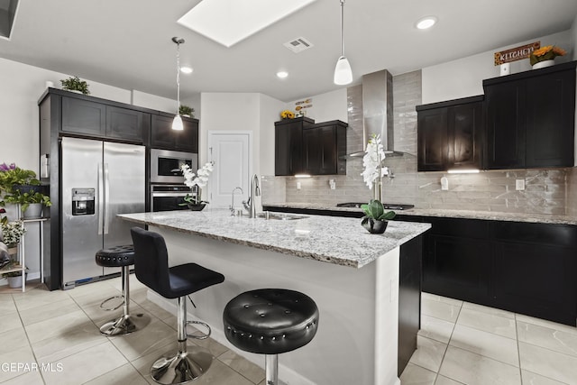 12405 Northumberg Dr, El Paso, TX 79928 - kitchen with stainless steel appliances, a sink, wall chimney exhaust hood, a skylight, and decorative backsplash