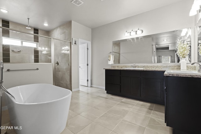 12405 Northumberg Dr, El Paso, TX 79928 - bathroom with a stall shower, a freestanding tub, double vanity, and baseboards