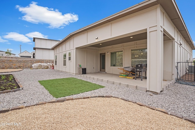12405 Northumberg Dr, El Paso, TX 79928 - back of property featuring board and batten siding and a patio