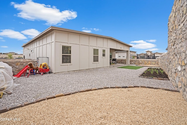 12405 Northumberg Dr, El Paso, TX 79928 - rear view of house with board and batten siding and a patio