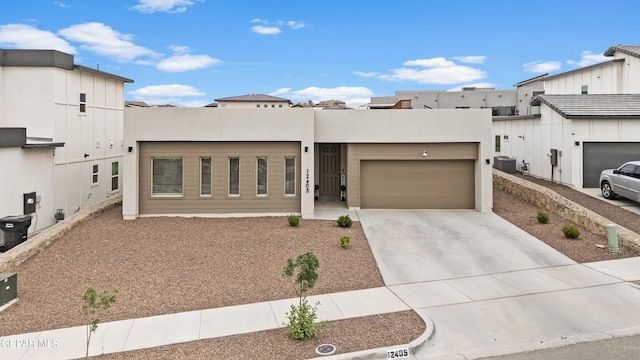 12405 Northumberg Dr, El Paso, TX 79928 - view of front of home with an attached garage, driveway, central AC unit, and stucco siding