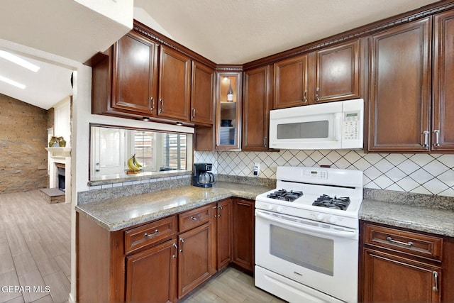10912 Duke Snider Cir, El Paso, TX 79934 - kitchen featuring white appliances, backsplash, light stone countertops, light wood-type flooring, and glass insert cabinets