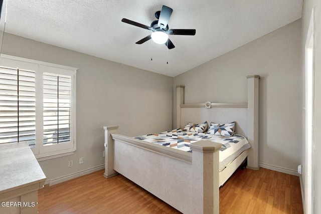 10912 Duke Snider Cir, El Paso, TX 79934 - bedroom with light wood-type flooring, baseboards, ceiling fan, and a textured ceiling