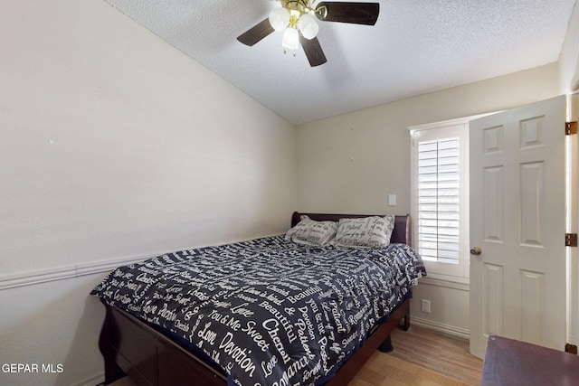 10912 Duke Snider Cir, El Paso, TX 79934 - bedroom featuring wood finished floors, lofted ceiling, a textured ceiling, and ceiling fan