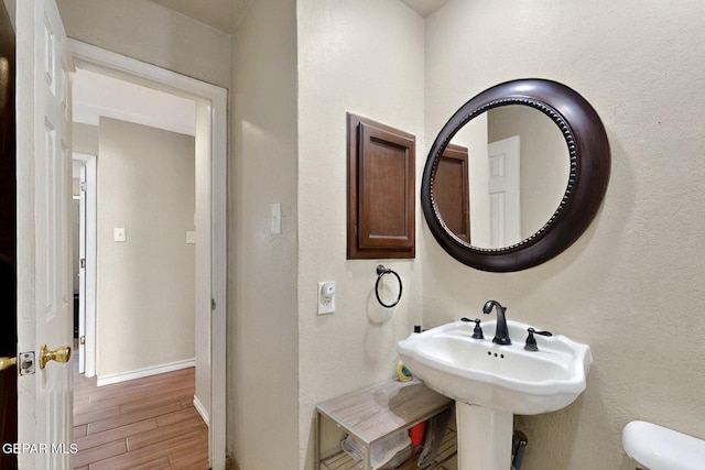 10912 Duke Snider Cir, El Paso, TX 79934 - bathroom with wood finished floors, toilet, baseboards, and a sink