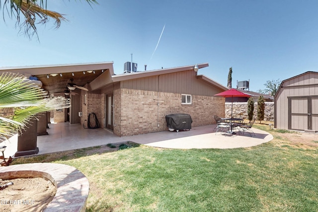 10912 Duke Snider Cir, El Paso, TX 79934 - back of property with a storage unit, ceiling fan, a patio, brick siding, and an outbuilding