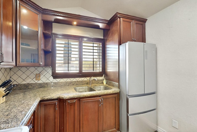 10912 Duke Snider Cir, El Paso, TX 79934 - kitchen with freestanding refrigerator, a sink, glass insert cabinets, backsplash, and lofted ceiling