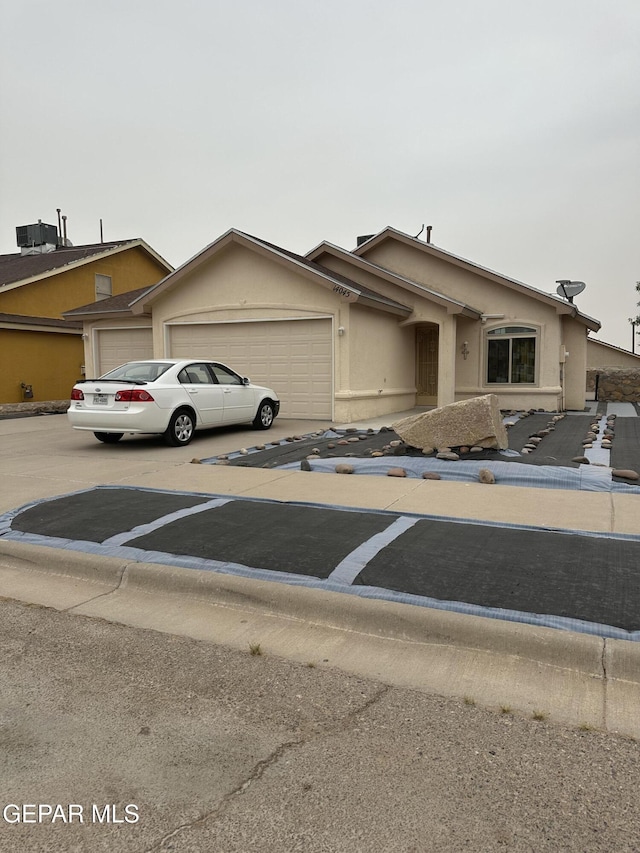 14045 Lago Seco Dr, Horizon City, TX 79928 - view of front of home featuring a garage, driveway, and stucco siding