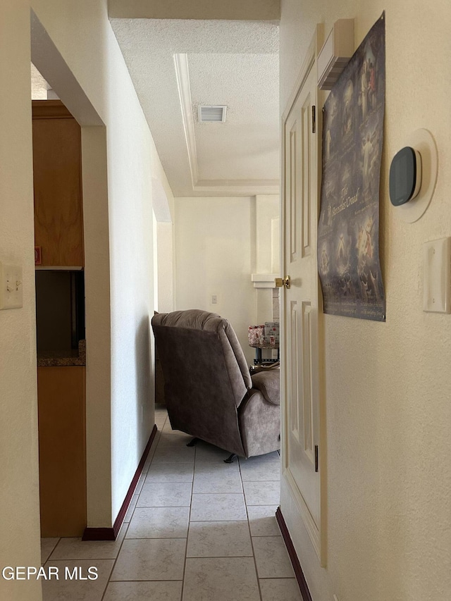 14045 Lago Seco Dr, Horizon City, TX 79928 - hallway featuring light tile patterned floors, a textured ceiling, and baseboards