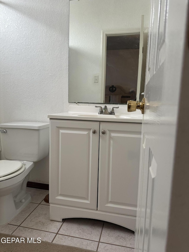 14045 Lago Seco Dr, Horizon City, TX 79928 - half bath featuring tile patterned flooring, toilet, vanity, and a textured wall