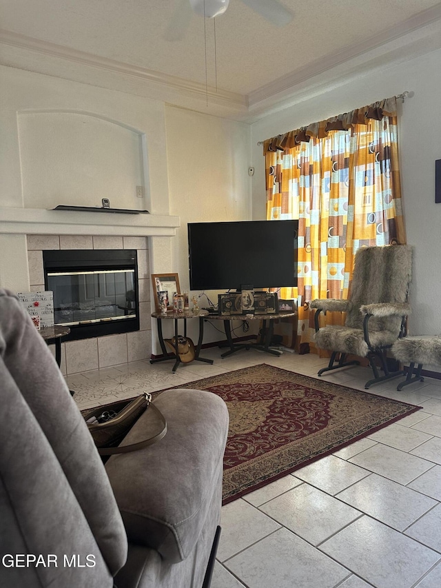 14045 Lago Seco Dr, Horizon City, TX 79928 - tiled living area with crown molding, a fireplace, and a ceiling fan