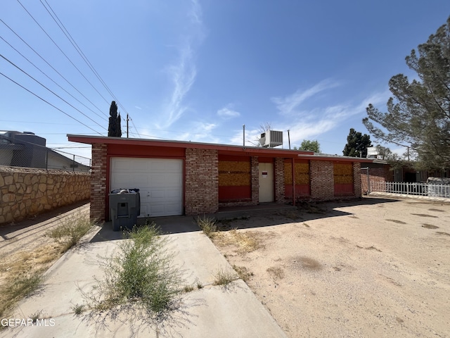 221 Maravilla Dr, El Paso, TX 79907 - view of front of home with brick siding, driveway, fence, and an attached garage