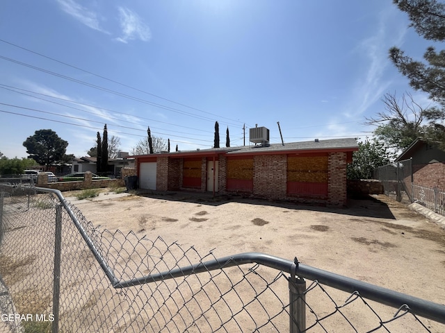 221 Maravilla Dr, El Paso, TX 79907 - view of front of house with a garage, brick siding, and central air condition unit