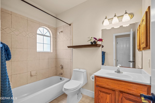 full bathroom featuring washtub / shower combination, vanity, and toilet