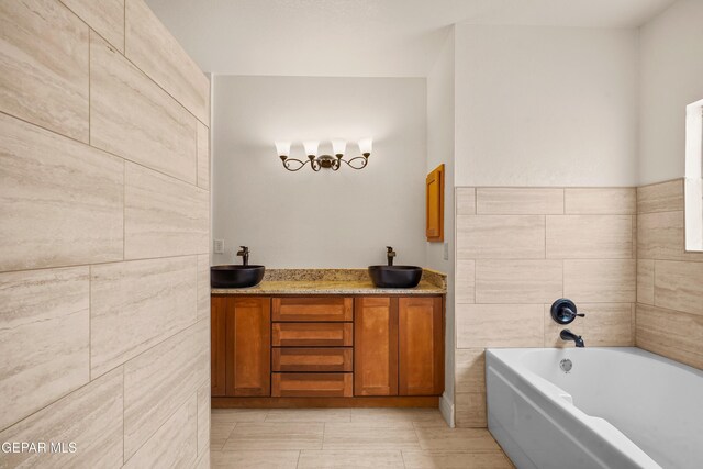 full bath featuring a sink, a garden tub, and tile patterned flooring