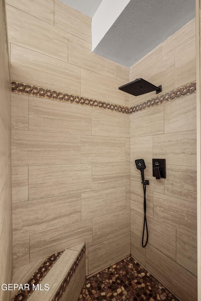 bathroom with a tile shower
