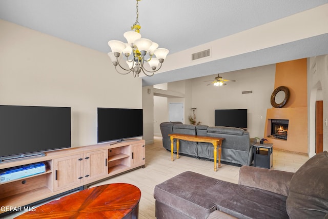 living room with a chandelier, ceiling fan, a lit fireplace, and light tile patterned floors