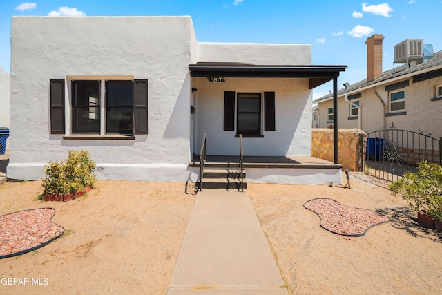3817 La Luz Ave, El Paso, TX 79903 - view of front of home with central AC, stucco siding, covered porch, and a gate