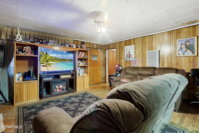 564 Chula Vista St, El Paso, TX 79915 - living area featuring wooden walls, wood finished floors, and a glass covered fireplace