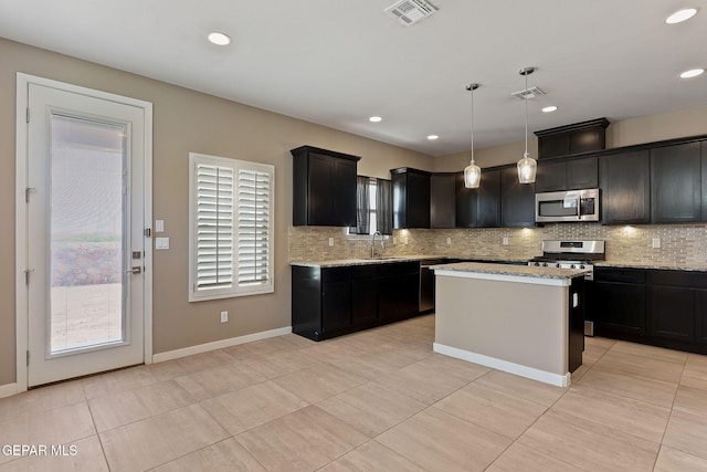 14172 Peyton Edwards Ave, El Paso, TX 79938 - kitchen with stainless steel appliances, a sink, backsplash, light tile patterned floors, and recessed lighting