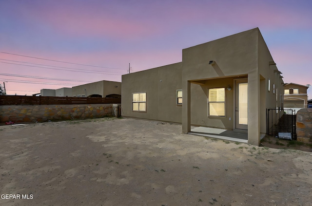 14172 Peyton Edwards Ave, El Paso, TX 79938 - back of property at dusk featuring fence and stucco siding