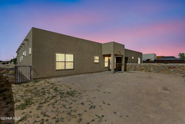 14172 Peyton Edwards Ave, El Paso, TX 79938 - back of property at dusk with stucco siding and fence
