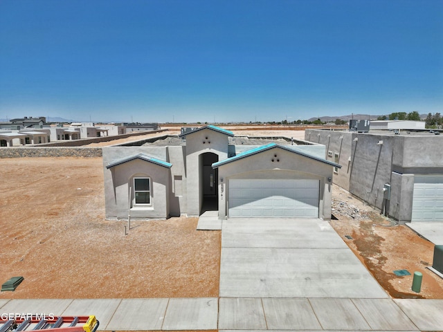 15341 Idea Ln, El Paso, TX 79938 - view of front of property featuring concrete driveway, a garage, and stucco siding