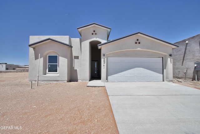 15341 Idea Ln, El Paso, TX 79938 - mediterranean / spanish-style house featuring concrete driveway, an attached garage, and stucco siding