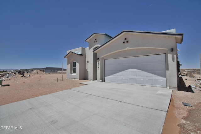 15341 Idea Ln, El Paso, TX 79938 - view of front of house with driveway, an attached garage, and stucco siding