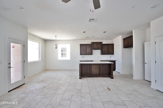 15341 Idea Ln, El Paso, TX 79938 - kitchen featuring a center island, dark brown cabinets, a ceiling fan, and pendant lighting