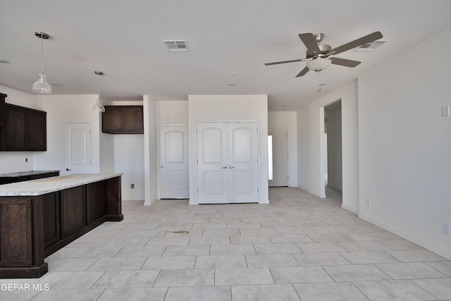 15341 Idea Ln, El Paso, TX 79938 - kitchen with a ceiling fan, dark brown cabinets, baseboards, and hanging light fixtures